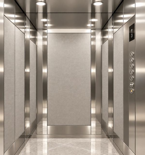 Silver Weave cabin: white linen panels framed in mirror stainless steel, SS COP with digital display, light marble floor