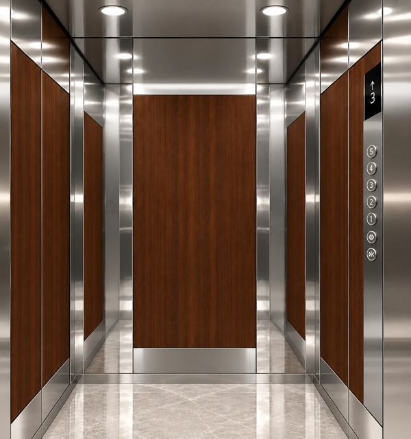 Walnut Salon cabin: dark wood panels framed in mirror stainless steel, light grey marble floor
