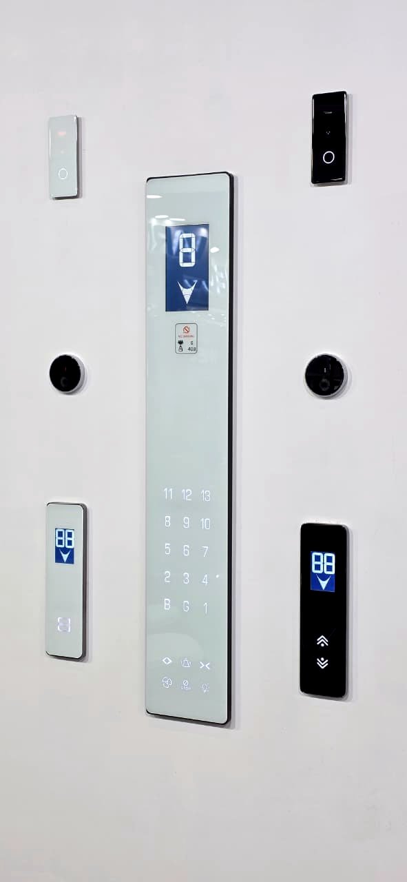 White-glass touch car operating panel with blue segment display, surrounded by white and black glass landing panels