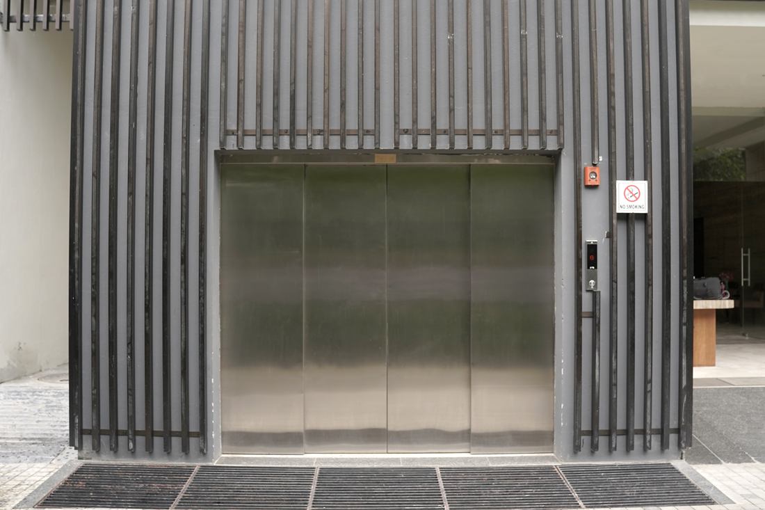 Wide stainless-steel car lift landing doors, closed