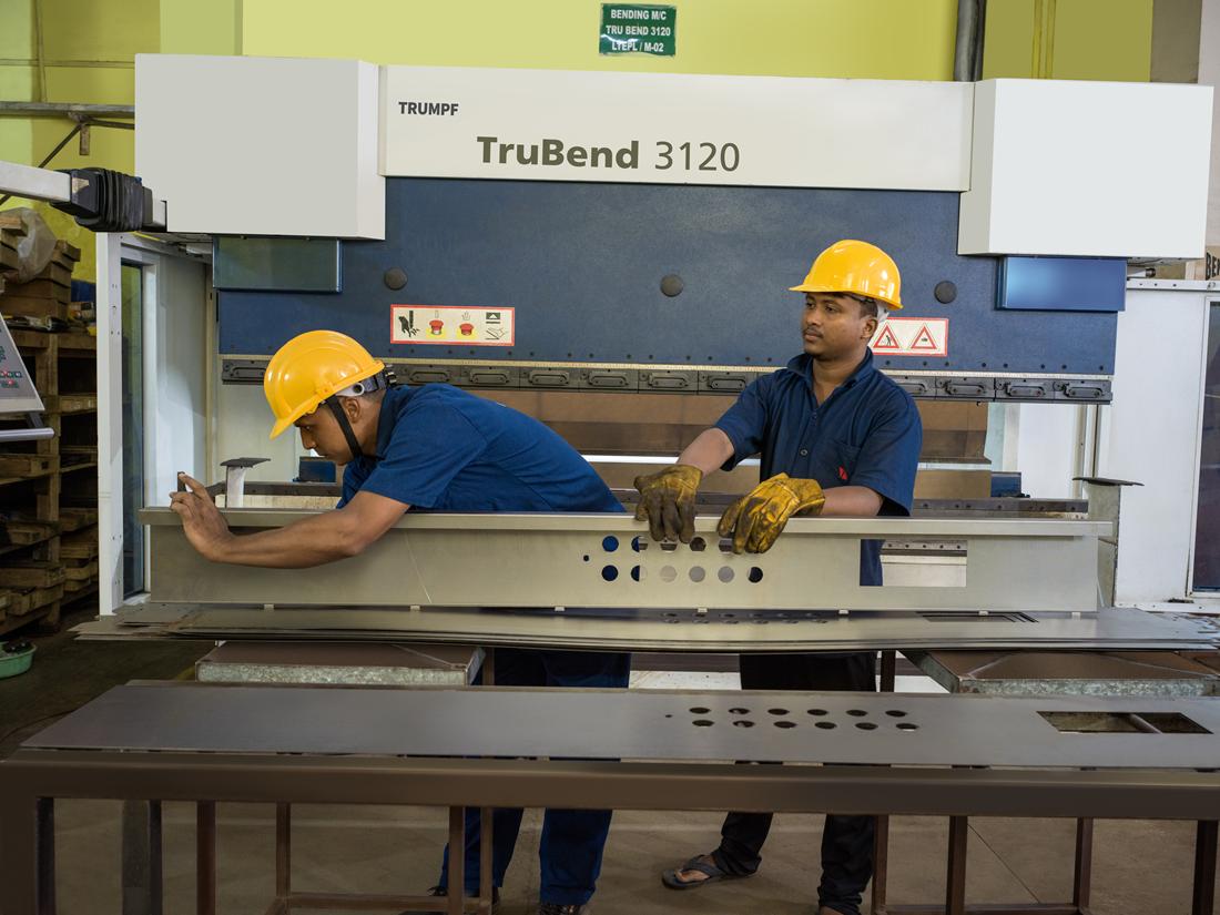 Two technicians bending sheet metal on a TRUMPF TruBend press brake
