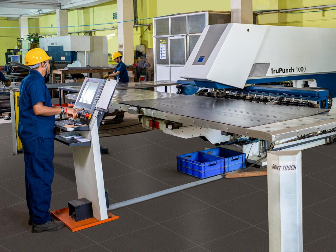 Technician operating a TRUMPF sheet-metal machine