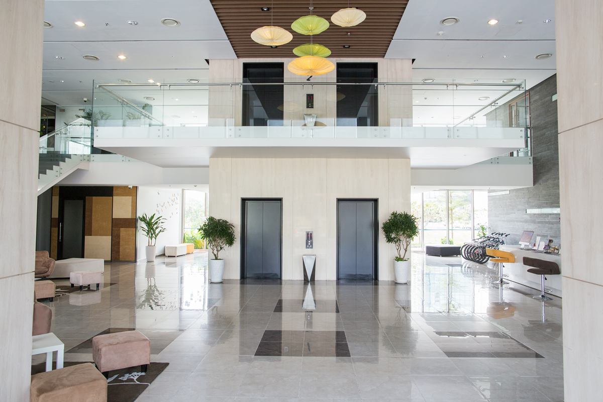 Pair of passenger lifts in a double-height commercial lobby
