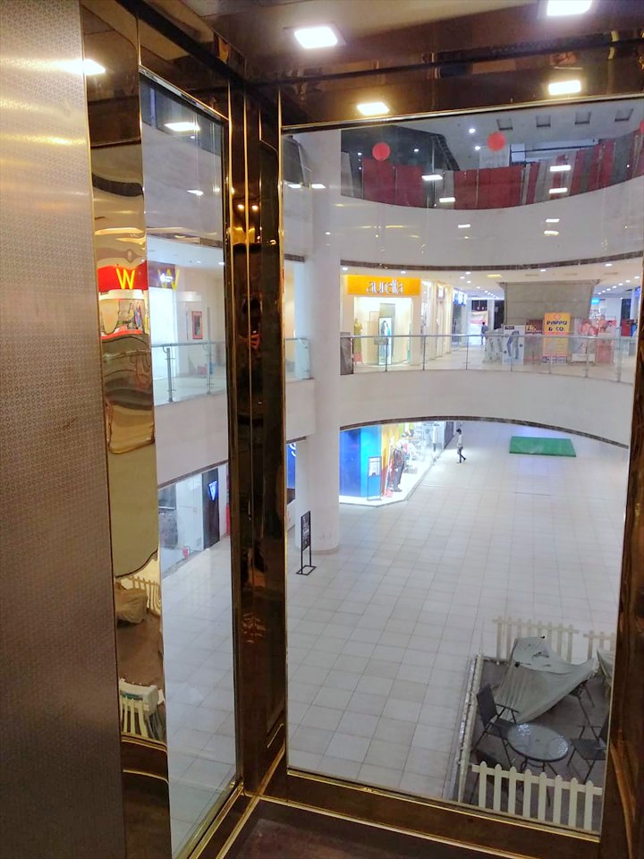 View across the mall atrium from inside the moving glass car